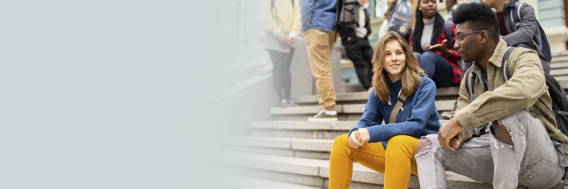 Group of young adults on steps in conversation