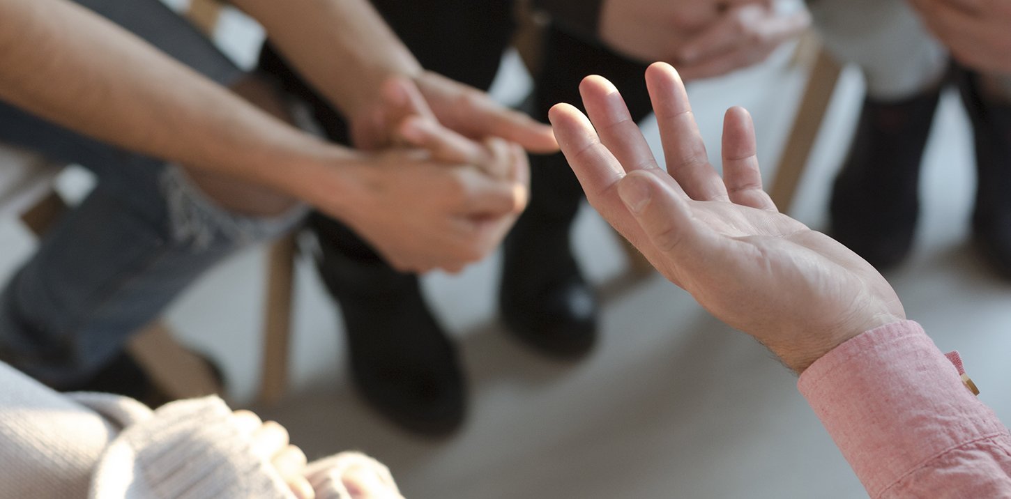 Group of adults talking, close up of hands