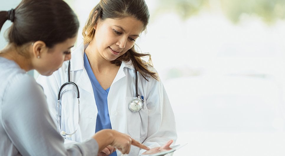 Doctor with patient looking at test results